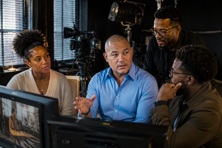 Black American professionals reviewing a creative project together