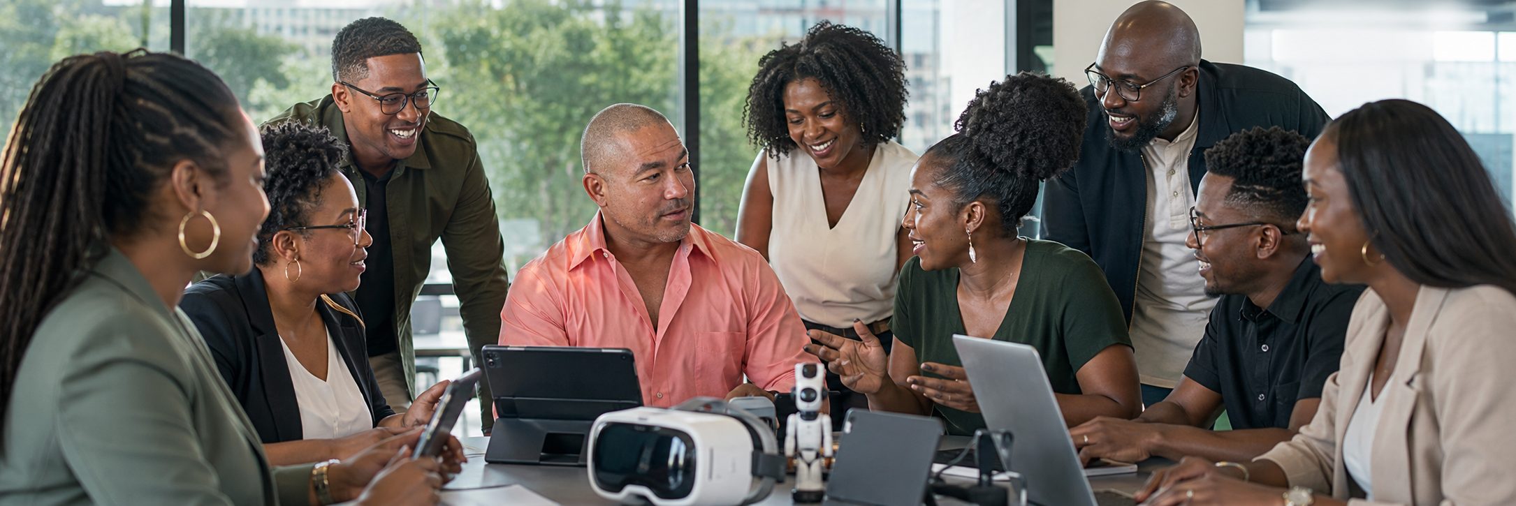 Black media professionals planning with a VR headset and camera equipment on the table